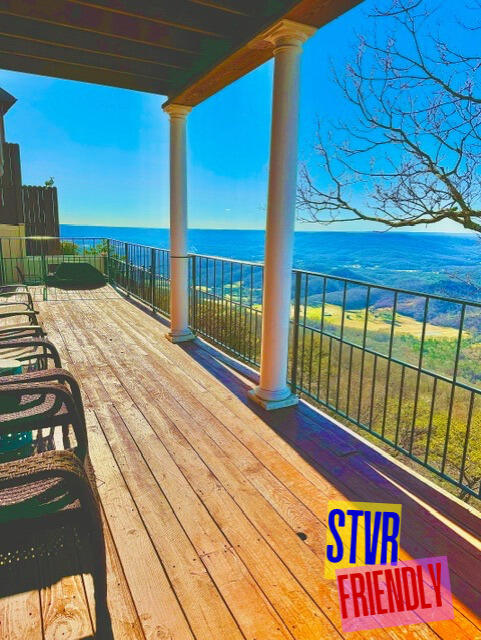 wooden deck featuring a water view