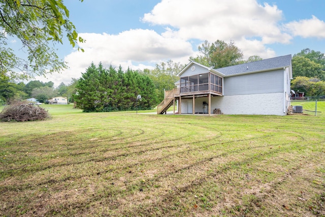 view of yard with a deck and a sunroom