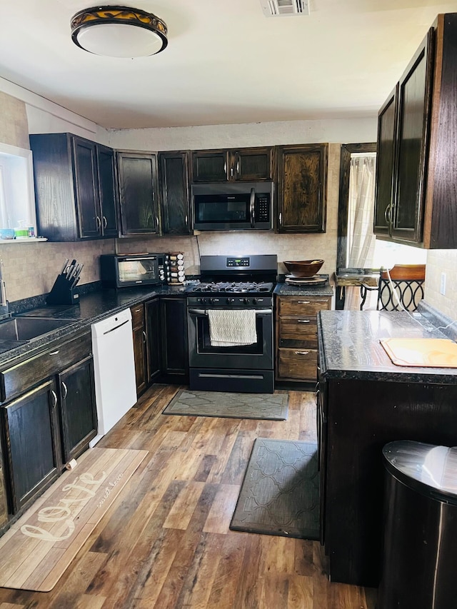 kitchen featuring appliances with stainless steel finishes, light hardwood / wood-style floors, and sink