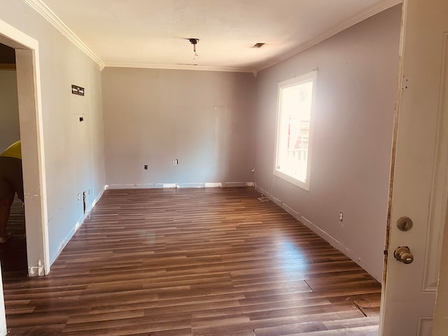 spare room with crown molding and dark hardwood / wood-style flooring