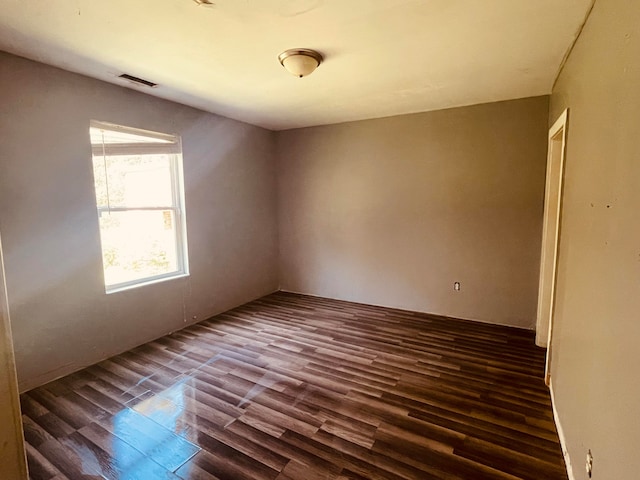 unfurnished room with dark hardwood / wood-style floors