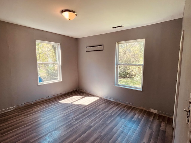 unfurnished room featuring dark wood-type flooring