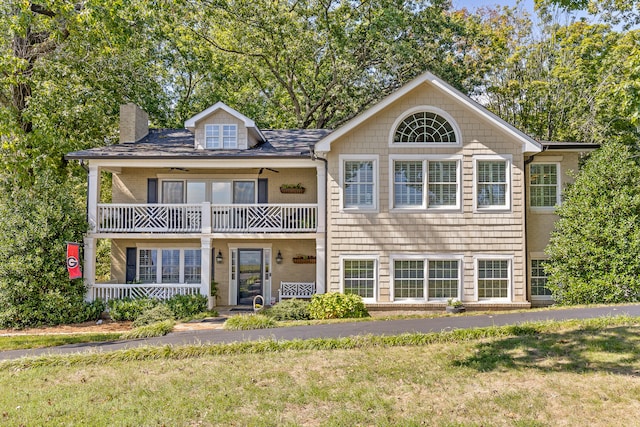 view of front of property with a balcony and a front yard