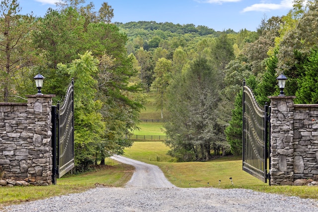 view of gate with a lawn