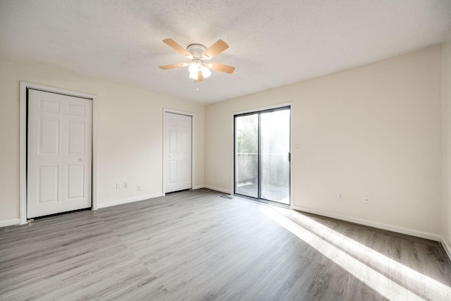 unfurnished bedroom with ceiling fan, a textured ceiling, light wood-type flooring, and access to exterior