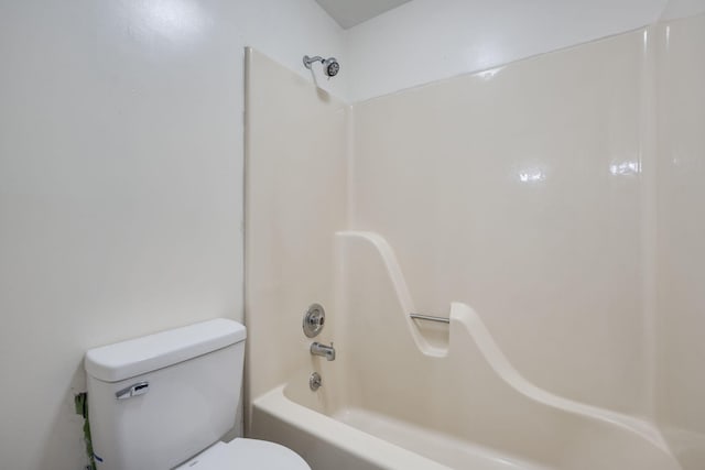 bathroom with toilet and bathtub / shower combination