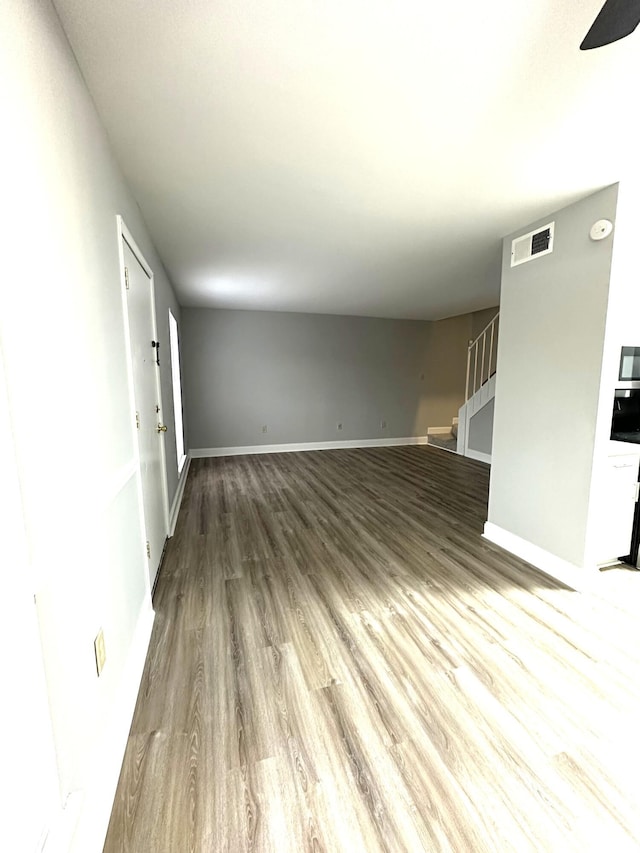 900 Mountain Creek Rd Unit K 143, Chattanooga, TN 37405 - unfurnished living room featuring stairway, wood finished floors, ceiling fan, baseboards, and visible vents