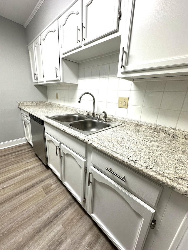 kitchen featuring sink, white cabinetry, tasteful backsplash, dishwasher, and hardwood / wood-style flooring