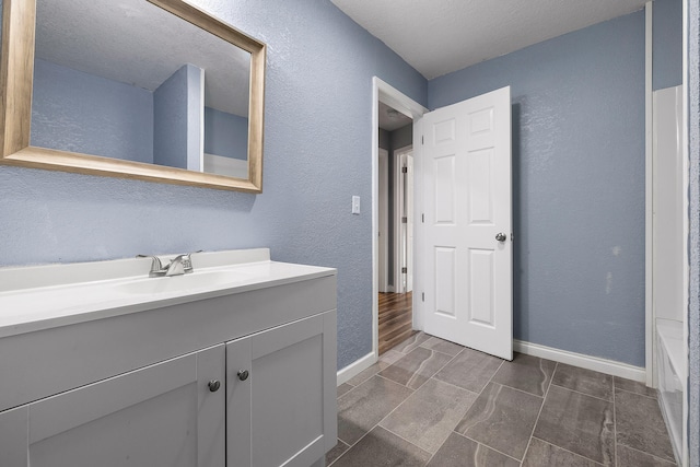 bathroom with vanity and a textured ceiling