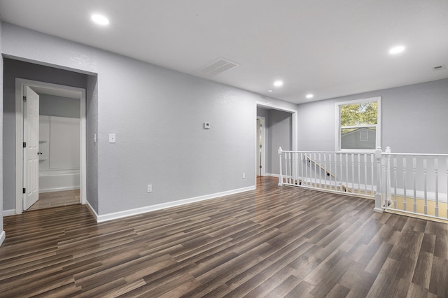 unfurnished room featuring dark hardwood / wood-style floors