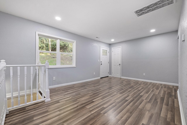 spare room with dark wood-type flooring