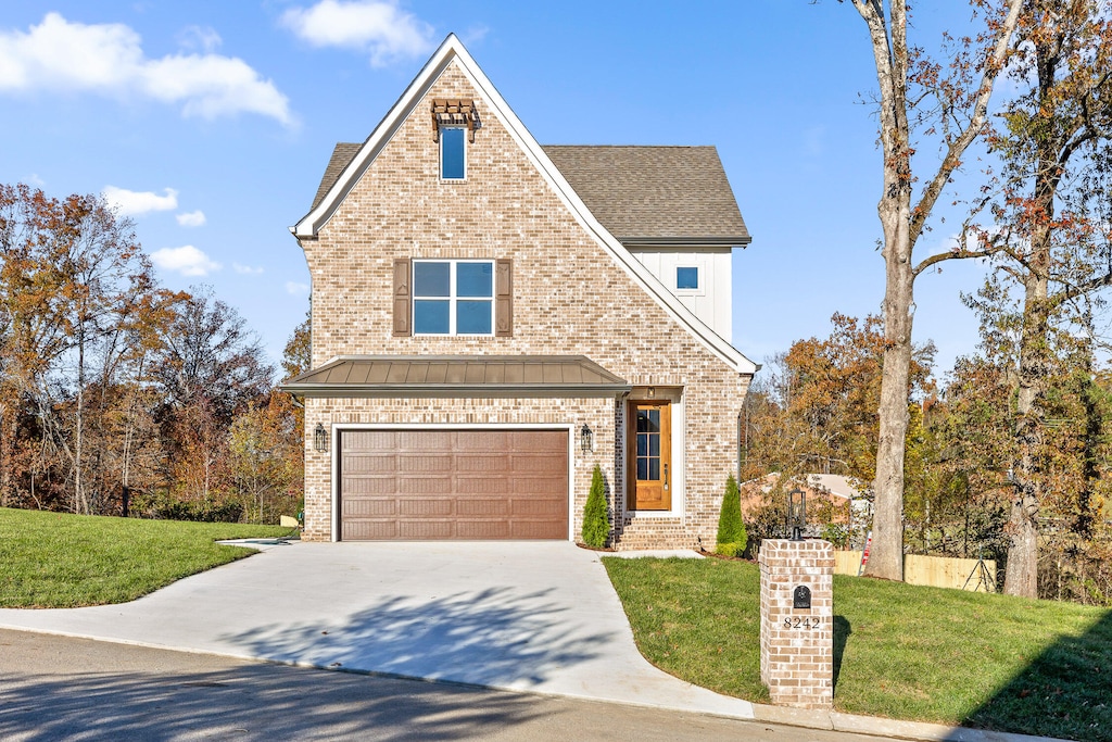 view of front of house featuring a front yard and a garage