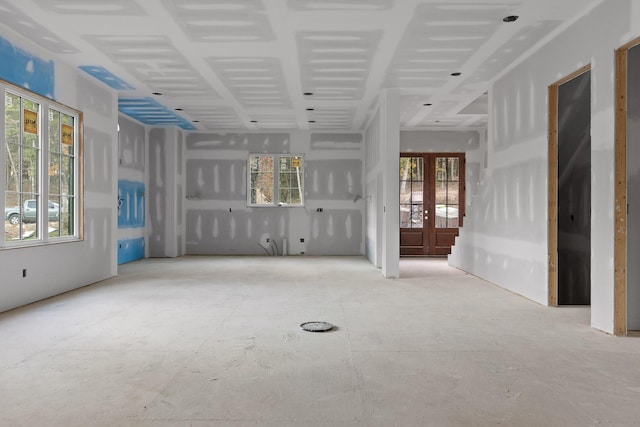 unfurnished living room featuring french doors and a wealth of natural light