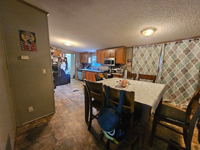 dining area featuring a textured ceiling