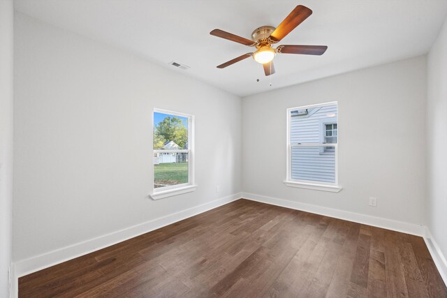 empty room featuring ceiling fan and dark hardwood / wood-style flooring