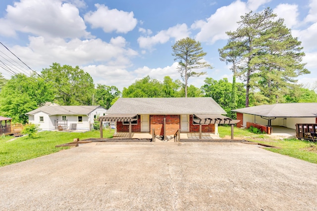 ranch-style home featuring a front yard, concrete driveway, a porch, and brick siding