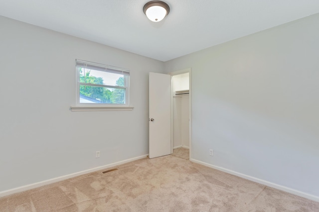carpeted spare room with baseboards and visible vents