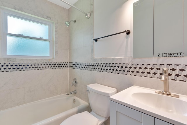 bathroom with vanity, tub / shower combination, toilet, tile walls, and tasteful backsplash