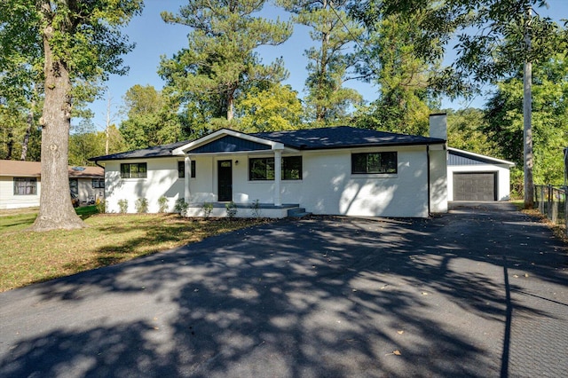 ranch-style house with a garage and a front lawn