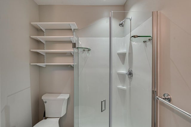 bathroom with toilet and a shower with door