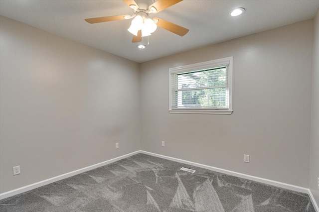 carpeted spare room featuring ceiling fan