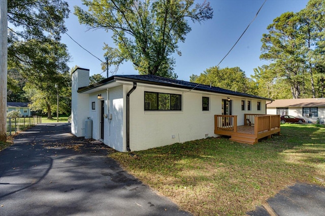 exterior space with a front lawn and a deck