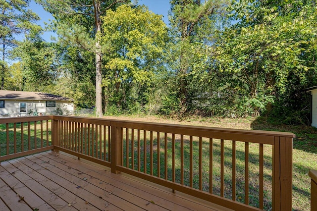 wooden terrace featuring a yard