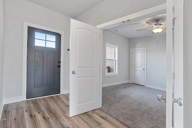 foyer entrance with light hardwood / wood-style floors, plenty of natural light, and ceiling fan