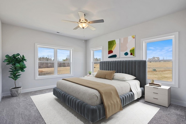 bedroom featuring baseboards, visible vents, light carpet, and ceiling fan