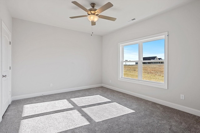 carpeted spare room with ceiling fan