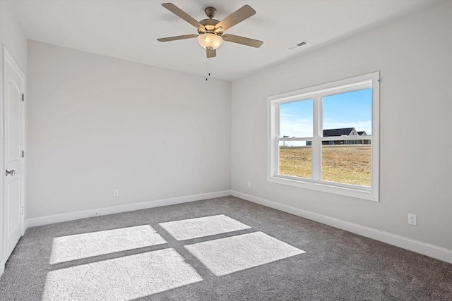 unfurnished room with visible vents, carpet, ceiling fan, and baseboards