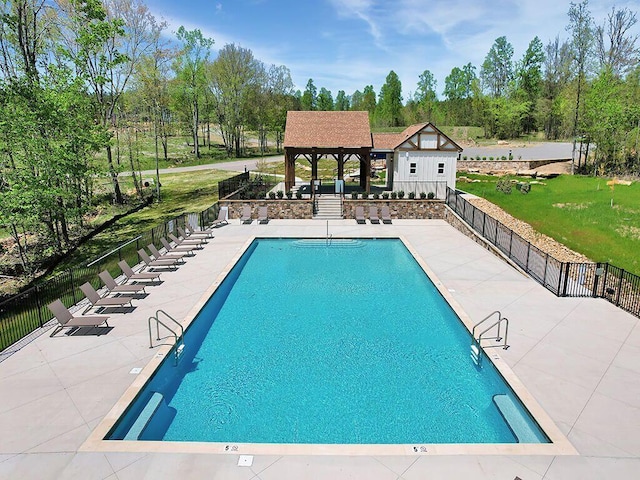pool with fence, a patio, a gazebo, and a yard