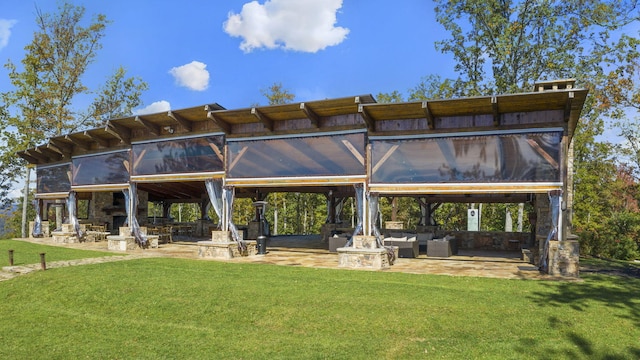 back of property with a yard and a patio