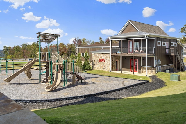 community jungle gym featuring a yard and cooling unit