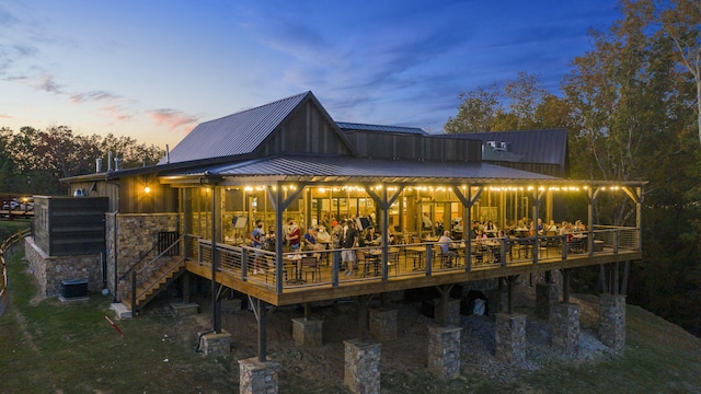 back house at dusk with a deck