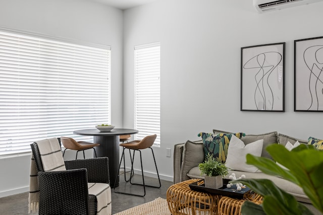 dining area featuring a wall unit AC and carpet flooring