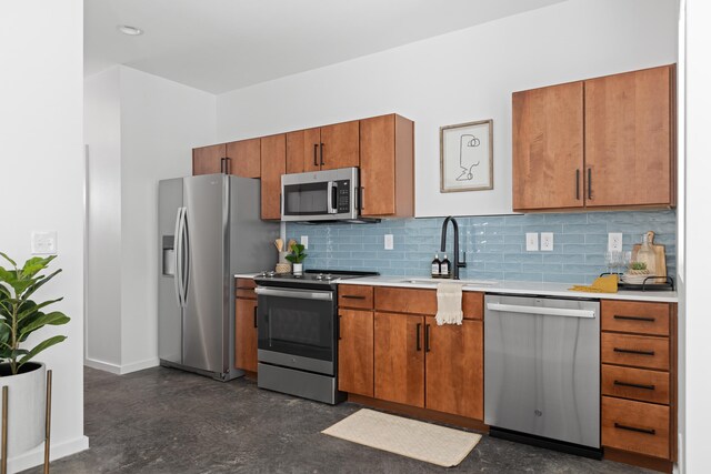 kitchen featuring appliances with stainless steel finishes, sink, and tasteful backsplash