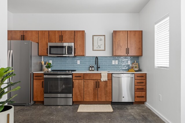 kitchen with stainless steel appliances, plenty of natural light, decorative backsplash, and sink