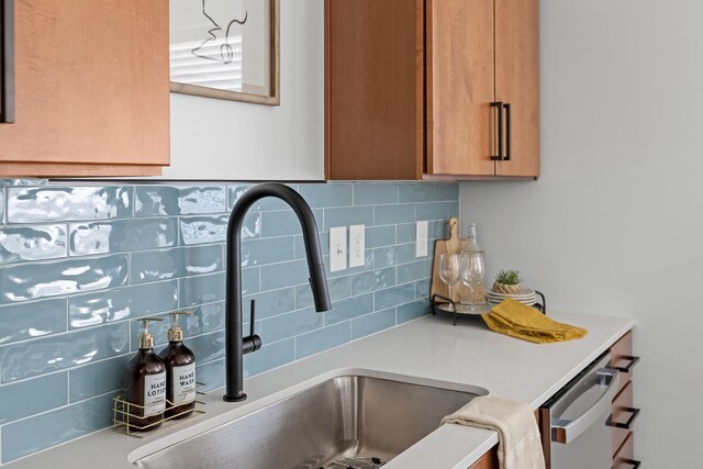 details with sink, tasteful backsplash, and stainless steel dishwasher