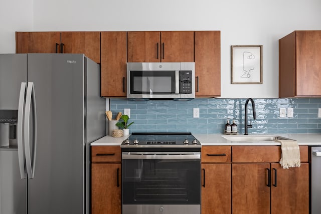 kitchen featuring appliances with stainless steel finishes, decorative backsplash, and sink