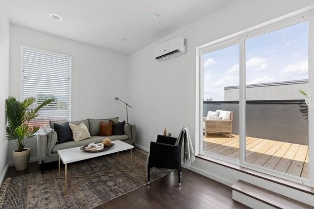 living room with dark wood-type flooring and a wall unit AC