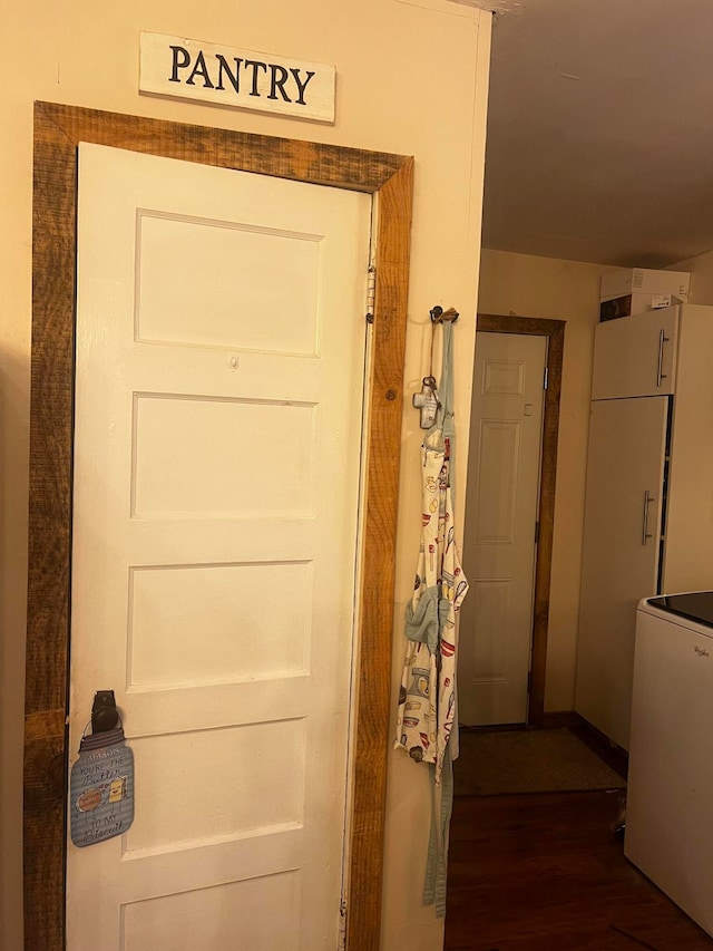 hall featuring hardwood / wood-style floors and washer / dryer