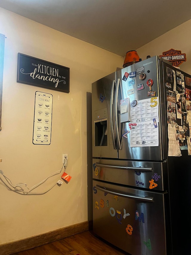 interior space with stainless steel refrigerator with ice dispenser and dark hardwood / wood-style floors