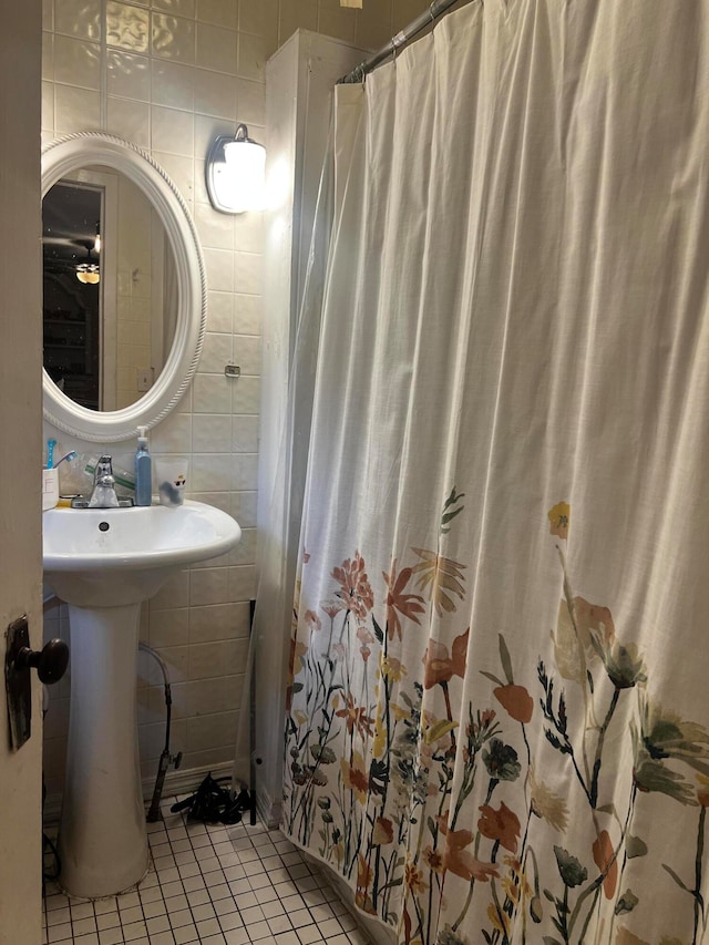 bathroom with tile patterned flooring, tile walls, and a shower with curtain