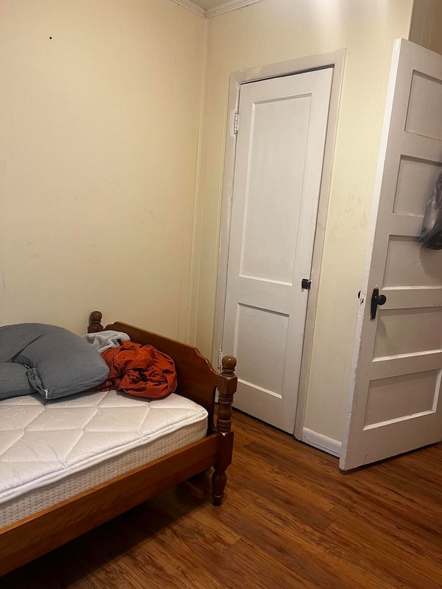 bedroom with dark wood-type flooring