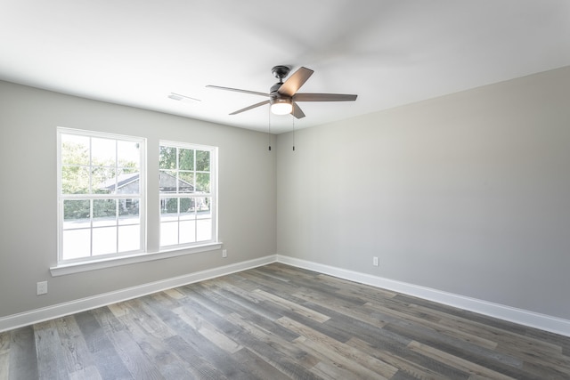 unfurnished room with ceiling fan and dark hardwood / wood-style floors