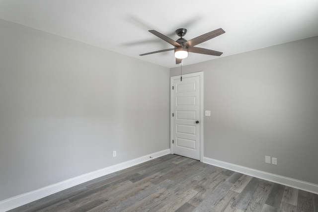 empty room featuring dark hardwood / wood-style flooring and ceiling fan