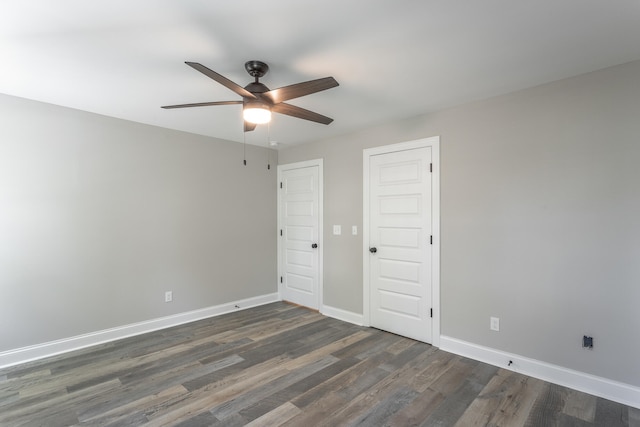 unfurnished bedroom featuring ceiling fan and dark hardwood / wood-style floors