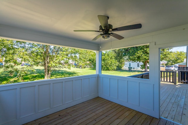 wooden deck featuring a yard and ceiling fan