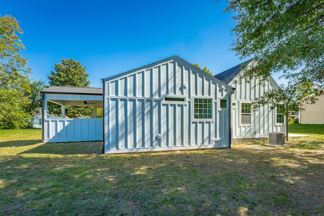 view of outbuilding with a yard and cooling unit